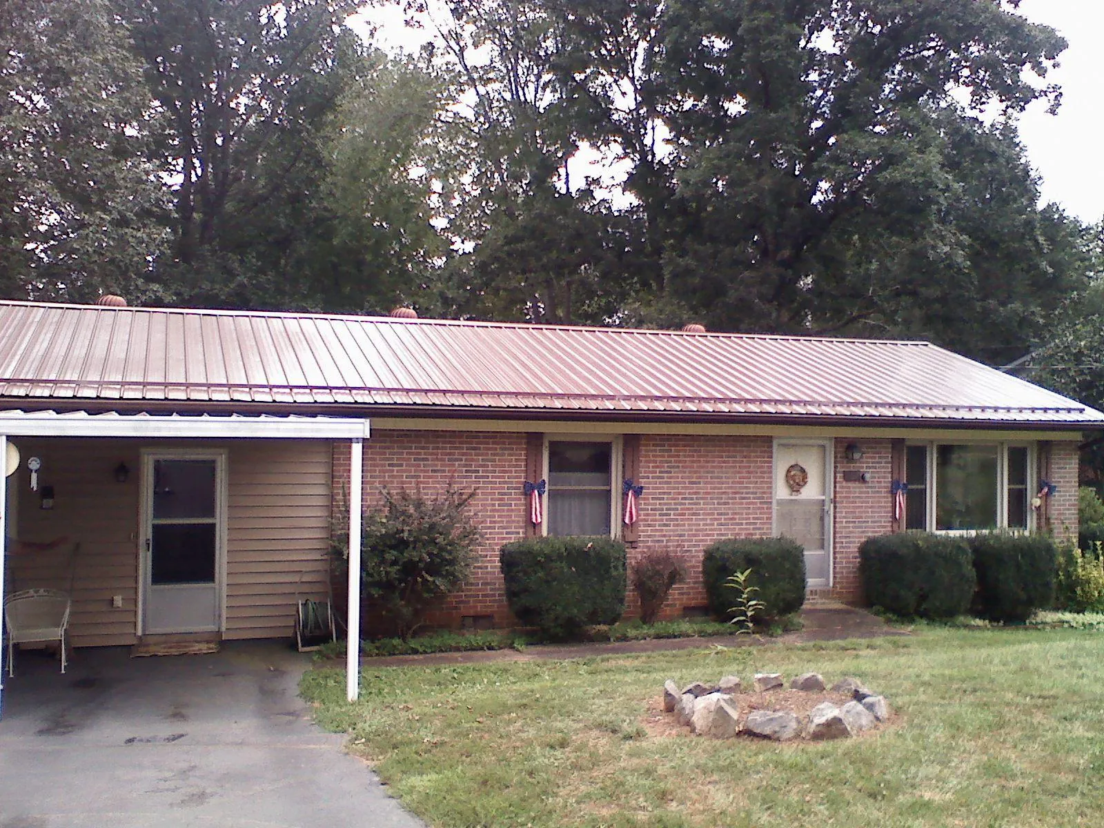 Bronze metal roof and carport on a brick ranch home — Roof Repair work by our crew in Bridgewater